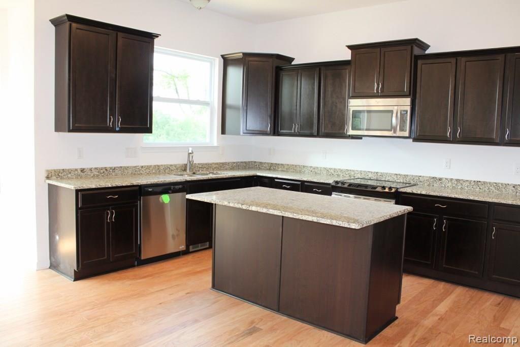 1467 Secretariat Way Howell, MI 48843 - Photo 4 of 7 05 Kitchen open to nook and great room (3).jpg