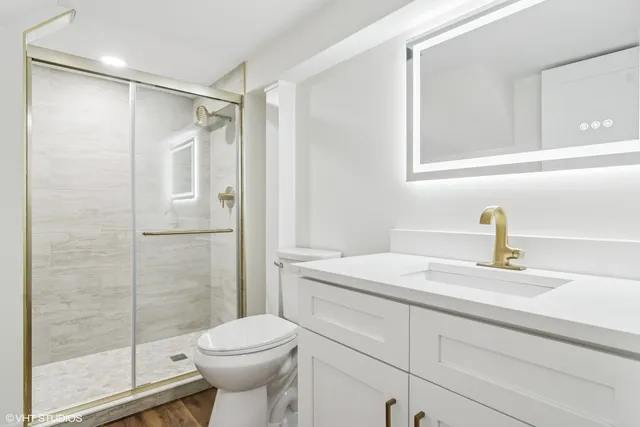 a bathroom with a sink toilet and shower