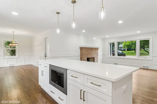 a kitchen with a stove and a wooden floor