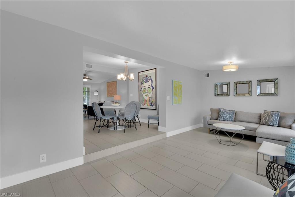2048 Harbor Lane Naples, FL 34104 - Photo 11 of 35 a living room with furniture and a dining table with potted plant
