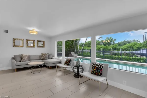 a living room with furniture and a large window