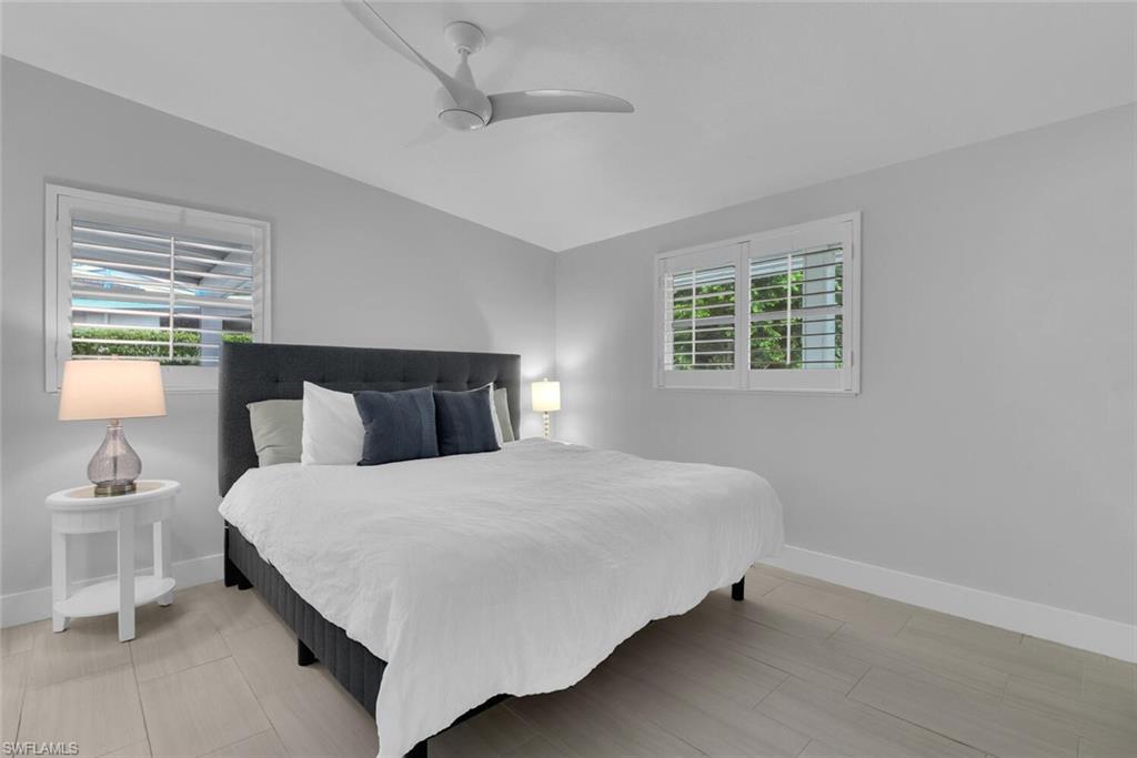 2048 Harbor Lane Naples, FL 34104 - Photo 14 of 35 a bedroom with a bed and window