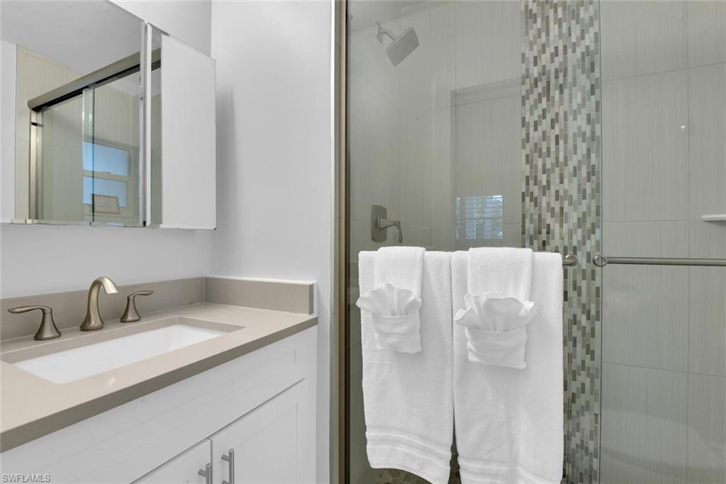 2048 Harbor Lane Naples, FL 34104 - Photo 16 of 35 a bathroom with a sink and mirror