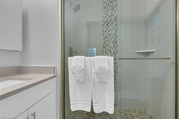 a bathroom with a shower and a sink