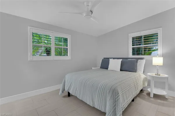 a bedroom with bed and window