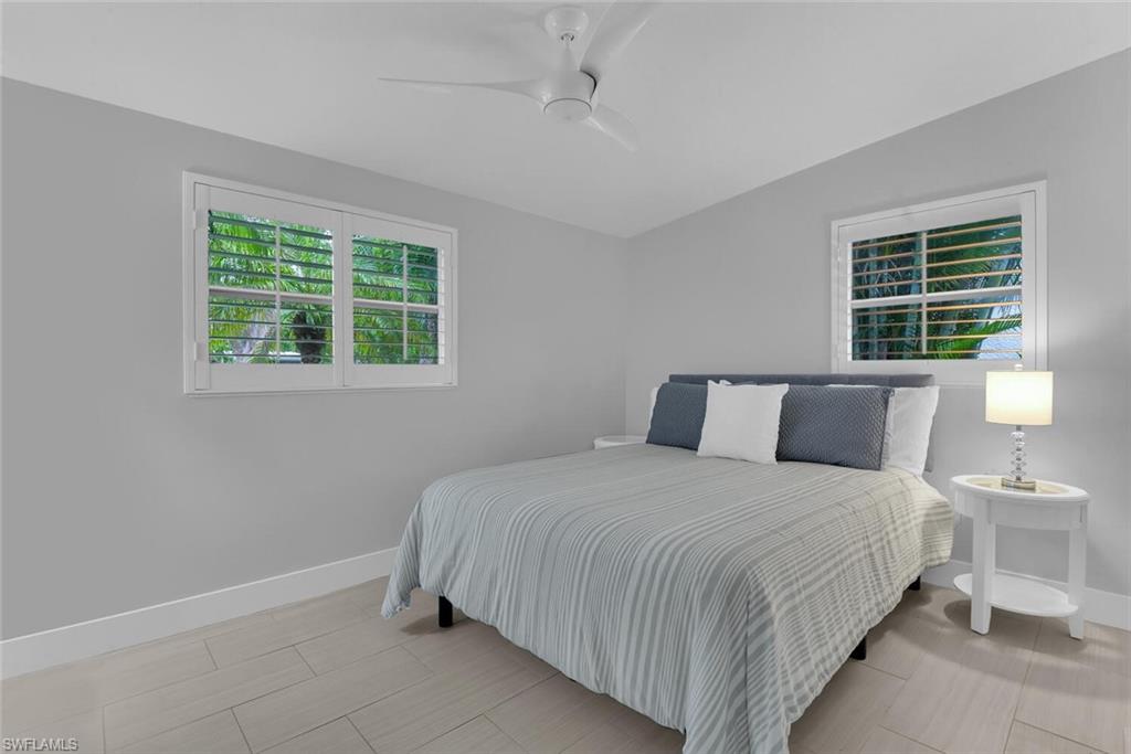 2048 Harbor Lane Naples, FL 34104 - Photo 18 of 35 a bedroom with bed and window