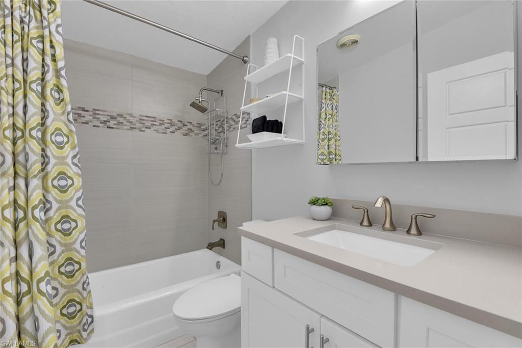 2048 Harbor Lane Naples, FL 34104 - Photo 20 of 35 a bathroom with a sink a toilet and shower