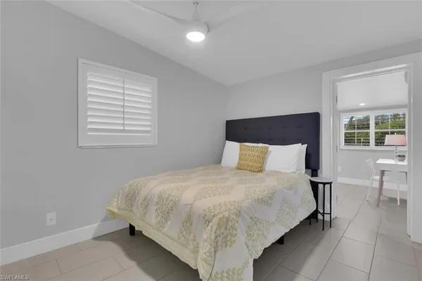 a bedroom with a bed and chair