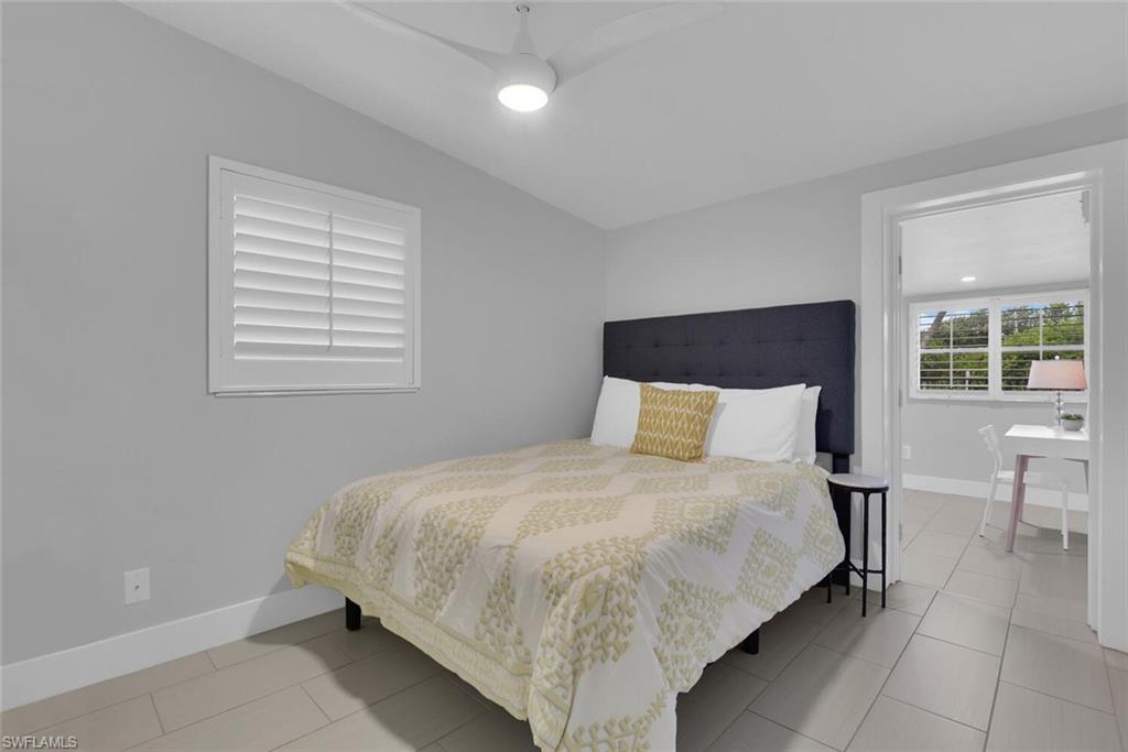 2048 Harbor Lane Naples, FL 34104 - Photo 21 of 35 a bedroom with a bed and chair