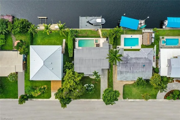 an aerial view of a house with a yard and potted plants