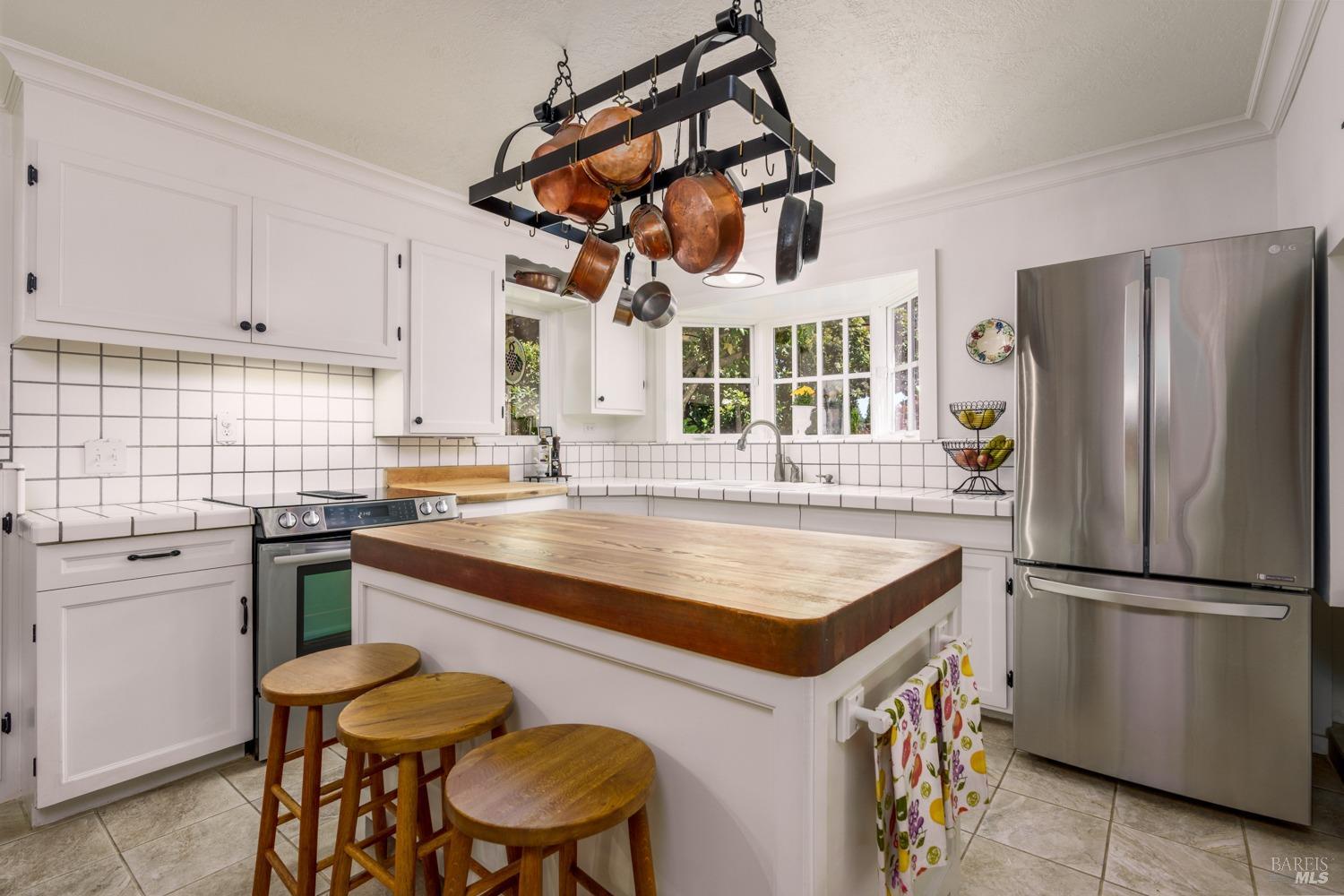 5700 Old River Road Ukiah, CA 95482 - Photo 20 of 56 a kitchen with stainless steel appliances granite countertop a table chairs a refrigerator and a sink