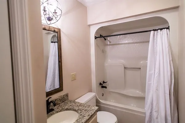 a bathroom with a shower curtain and a sink