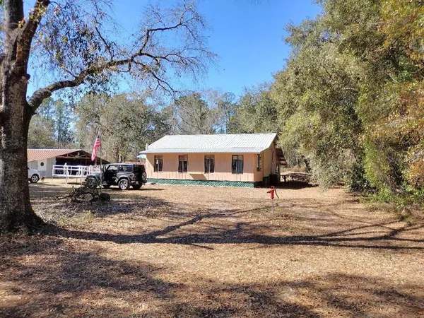 a view of a house with snow on the side of the road