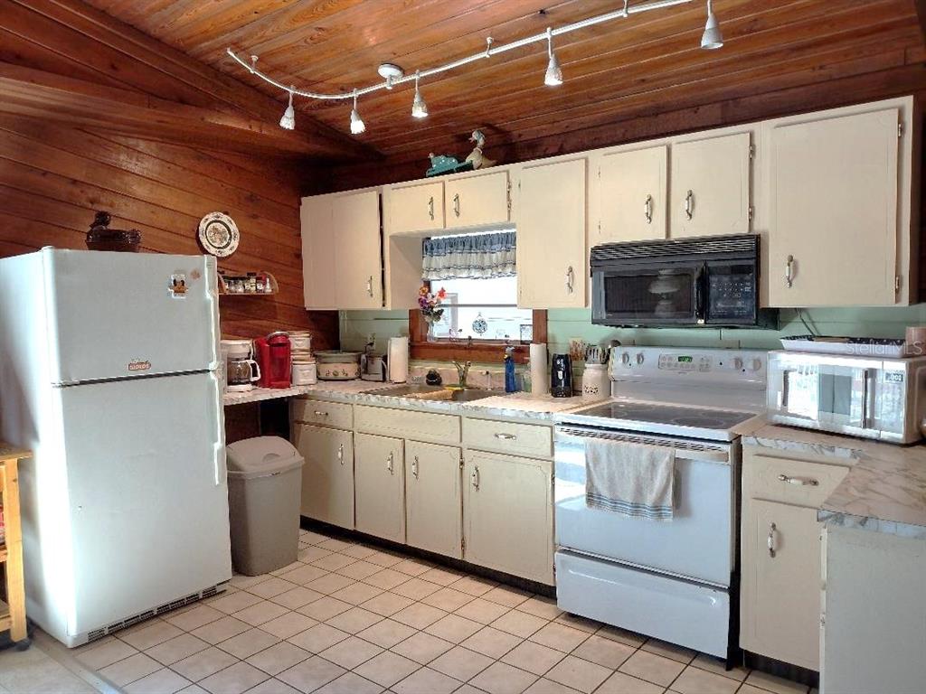 1916 Laurel Avenue Bunnell, FL 32110 - Photo 3 of 31 a kitchen with cabinets appliances a sink and a counter top space