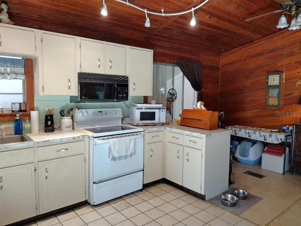 a kitchen with stainless steel appliances white cabinets and a sink
