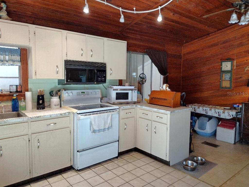 1916 Laurel Avenue Bunnell, FL 32110 - Photo 4 of 31 a kitchen with stainless steel appliances white cabinets and a sink