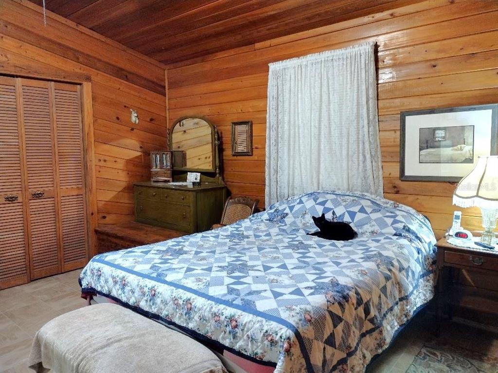1916 Laurel Avenue Bunnell, FL 32110 - Photo 7 of 31 a bedroom with a bed and wooden floor