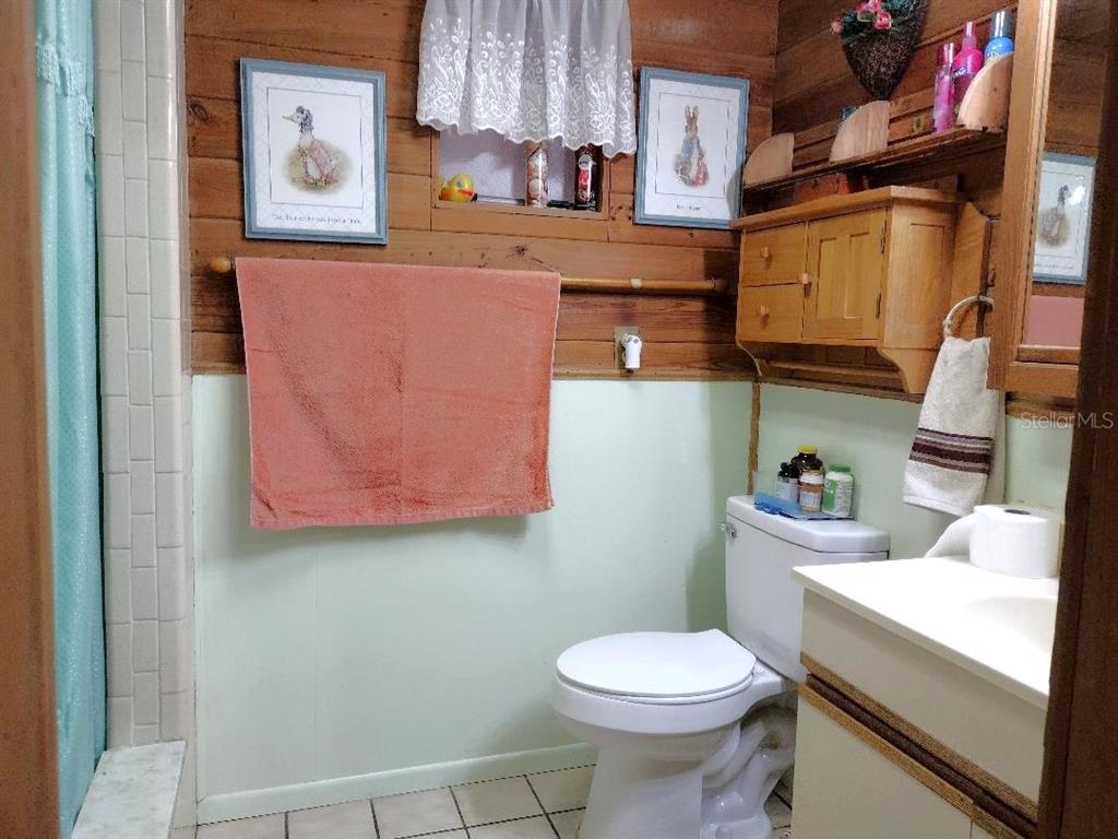 1916 Laurel Avenue Bunnell, FL 32110 - Photo 8 of 31 a bathroom with a sink a toilet and a mirror