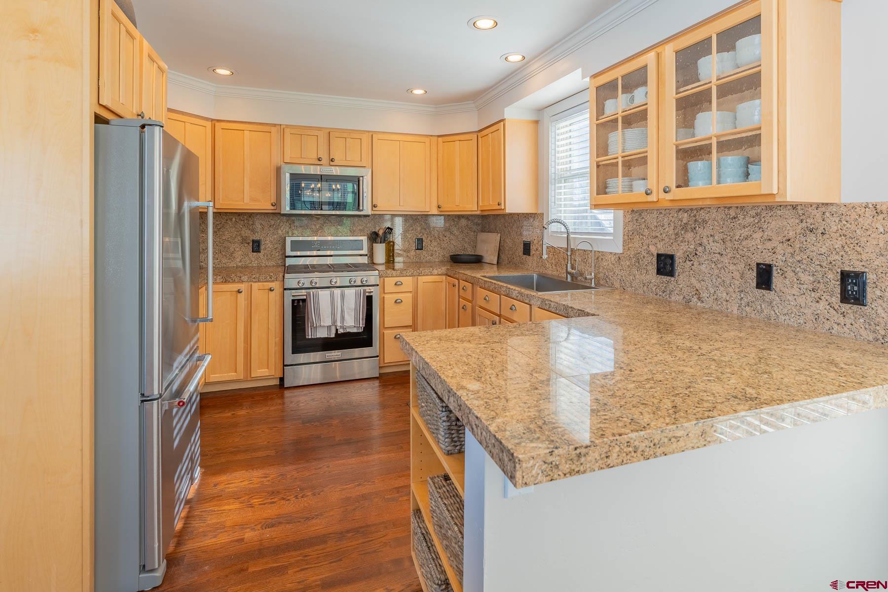 1 7th Street, Unit B Crested Butte, CO 81224 - Photo 11 of 35 a kitchen with stainless steel appliances granite countertop a refrigerator a sink a stove and oven