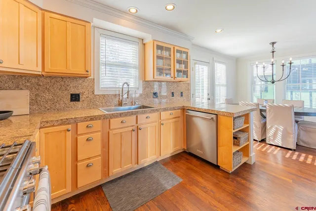 a kitchen with a sink window and cabinets