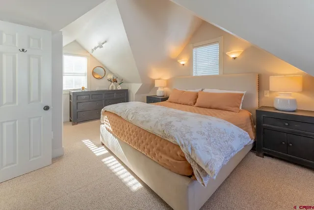 a bedroom with a large bed and a window