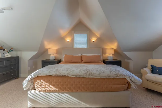 a spacious bedroom with a bed and a couch