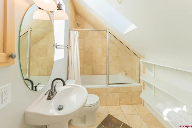 a bathroom with a sink a shower and a mirror