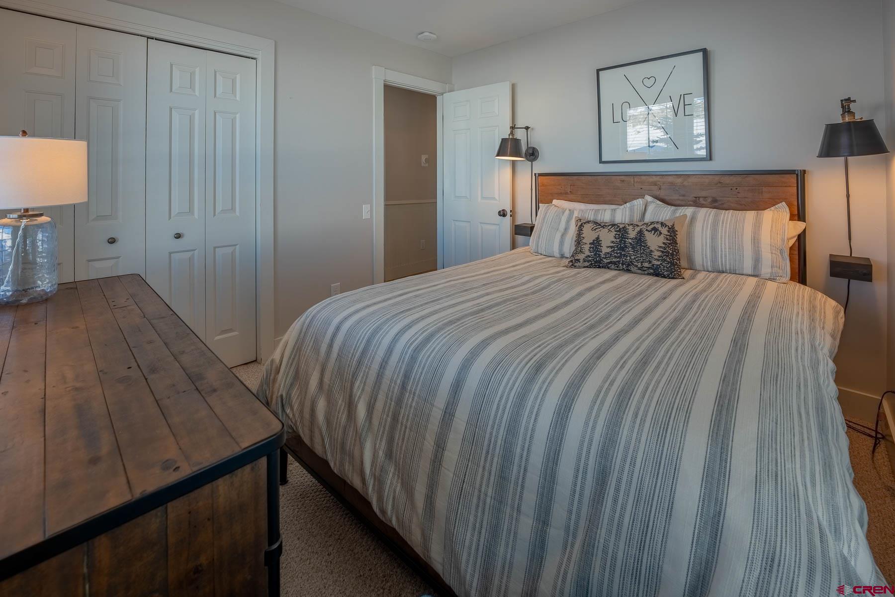 1 7th Street, Unit B Crested Butte, CO 81224 - Photo 24 of 35 a bedroom with a bed and a lamp on table