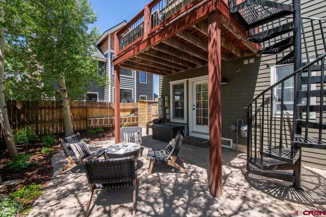 a view of a patio with table and chairs and potted plants