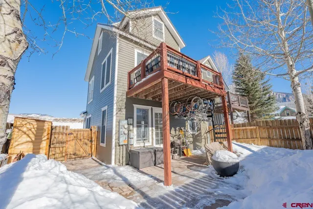 a view of a house with a chairs and table in the patio