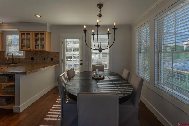 a view of a kitchen area with furniture and wooden floor