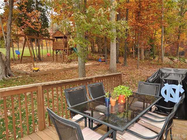 5325 Indigo Moon Way Raleigh, NC 27613 - Photo 11 of 13 The large wooded backyard has a playset.