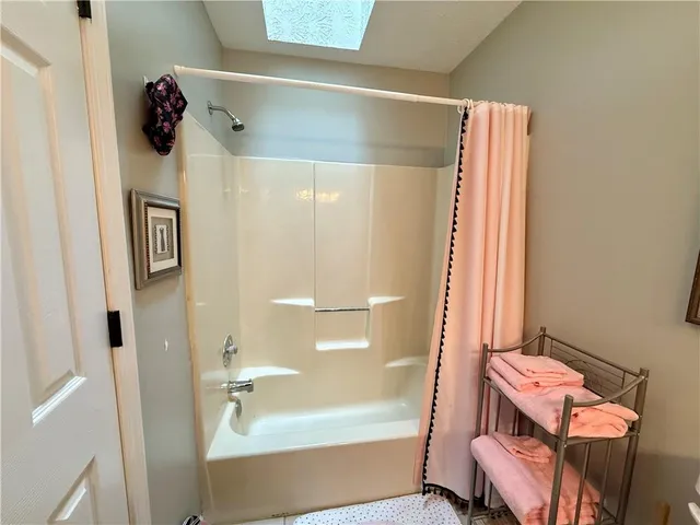 a bathroom with a bathtub and shower