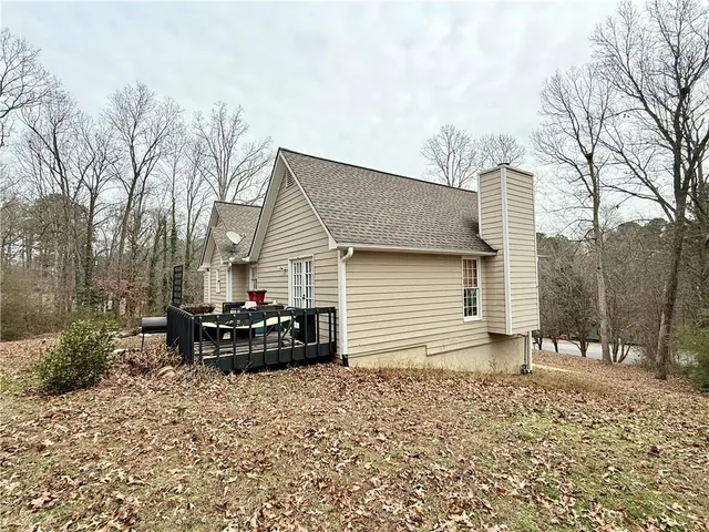 a backyard of a house with table and chairs