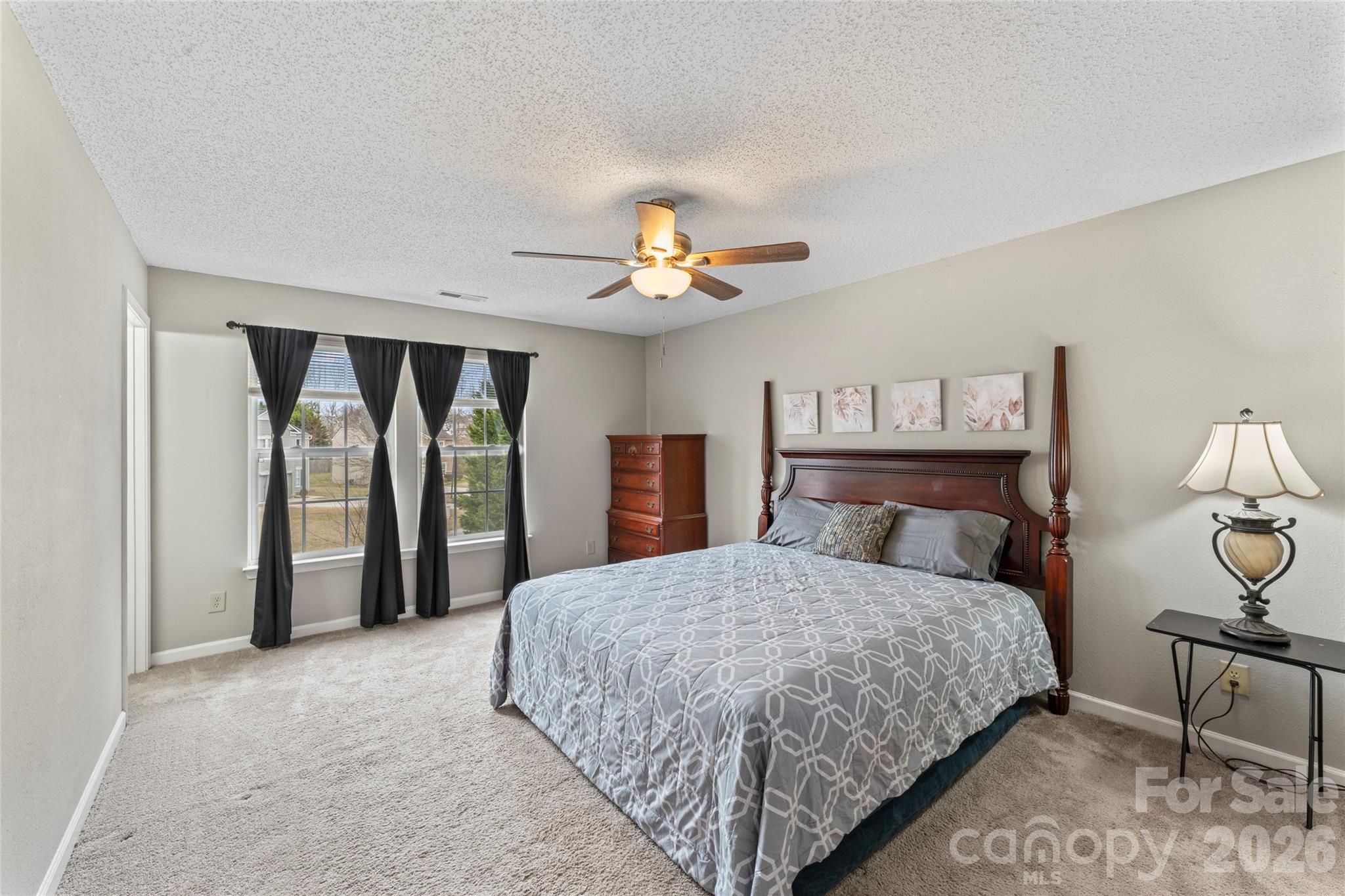 4208 Shasta Circle Clover, SC 29710 - Photo 32 of 41 a bedroom with a large bed and a chandelier