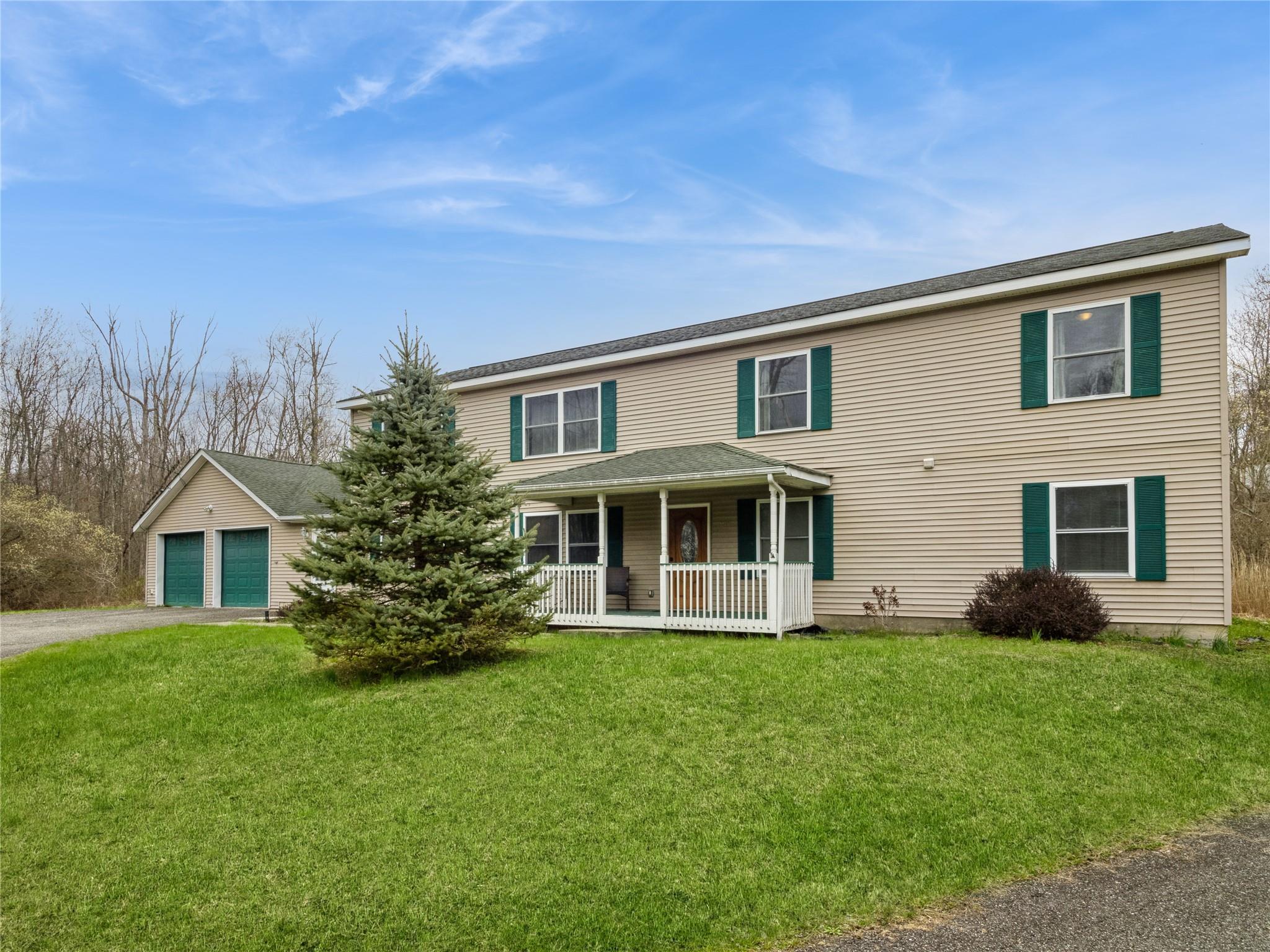 29 Dandelion Lane Wallkill, NY 12589 - Photo 2 of 50 a front view of a house with a yard and trees