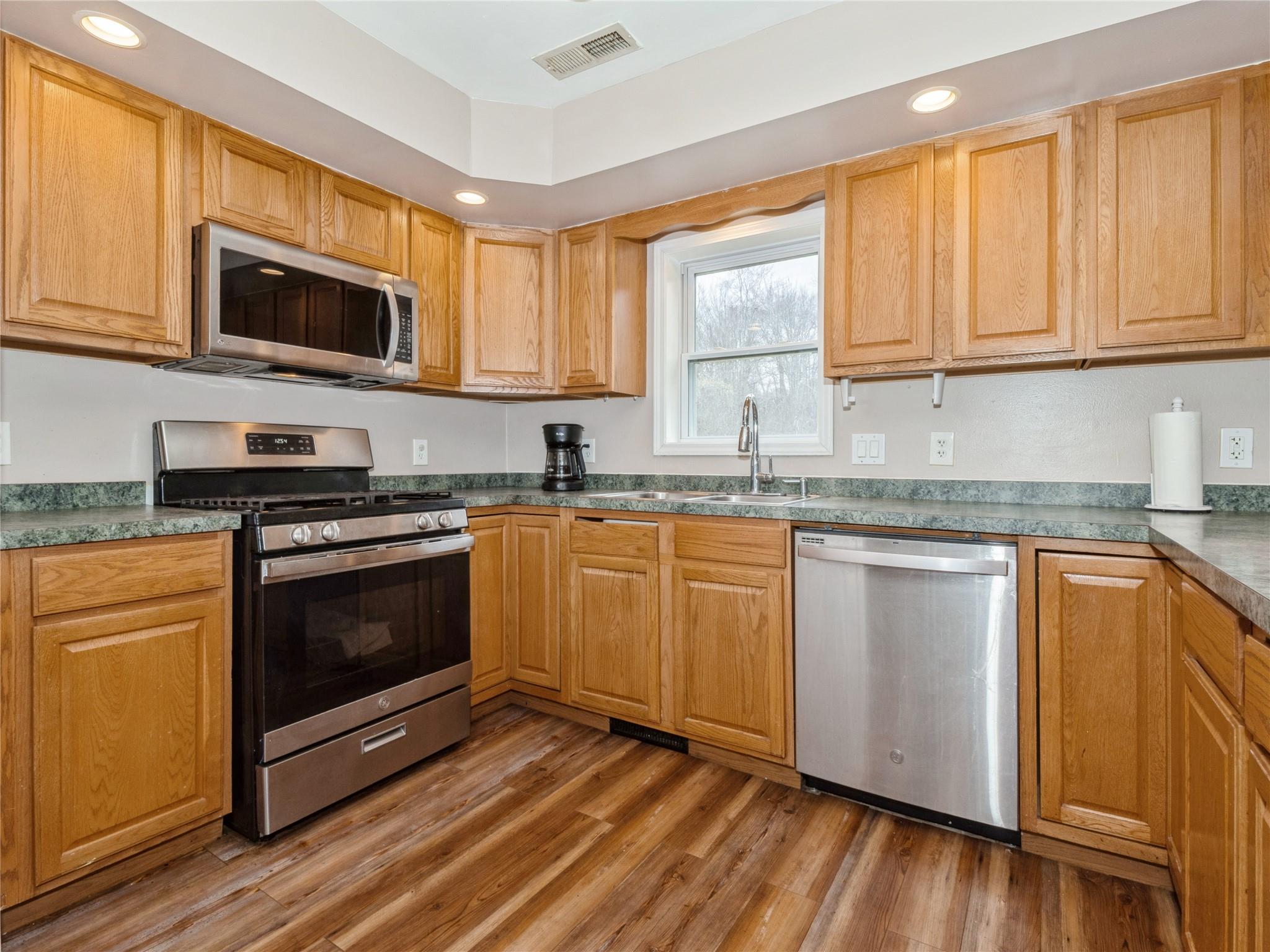 29 Dandelion Lane Wallkill, NY 12589 - Photo 22 of 50 a kitchen with granite countertop a sink cabinets and stainless steel appliances