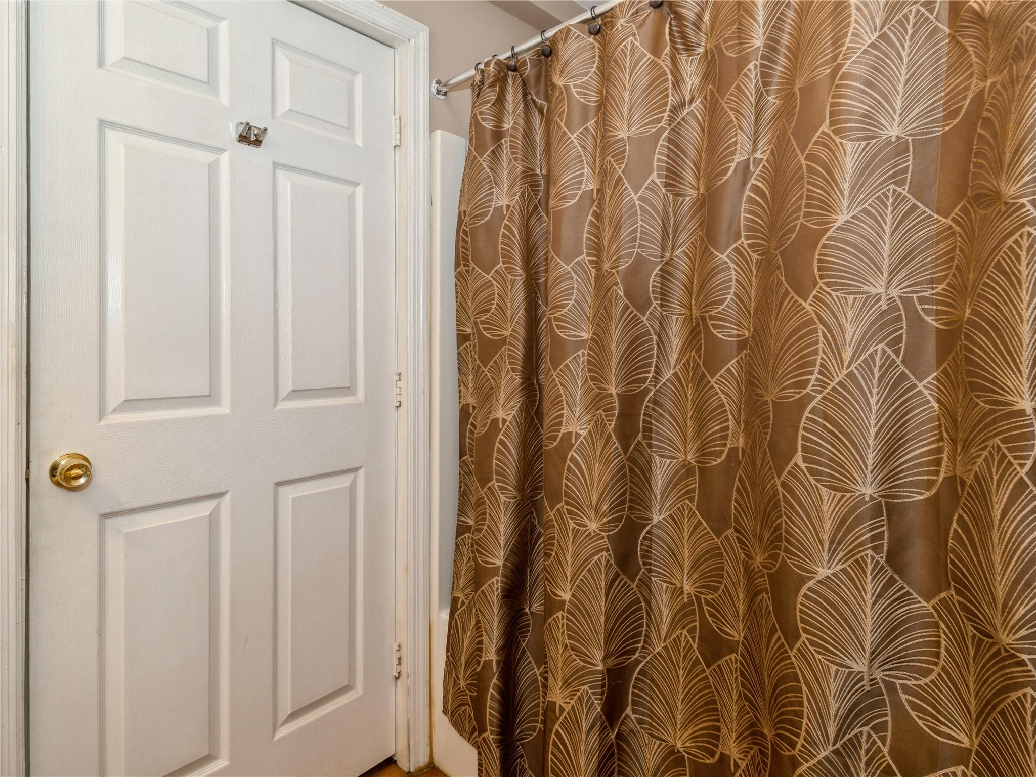 29 Dandelion Lane Wallkill, NY 12589 - Photo 30 of 50 a view of a bathroom with a white door and a shower curtain