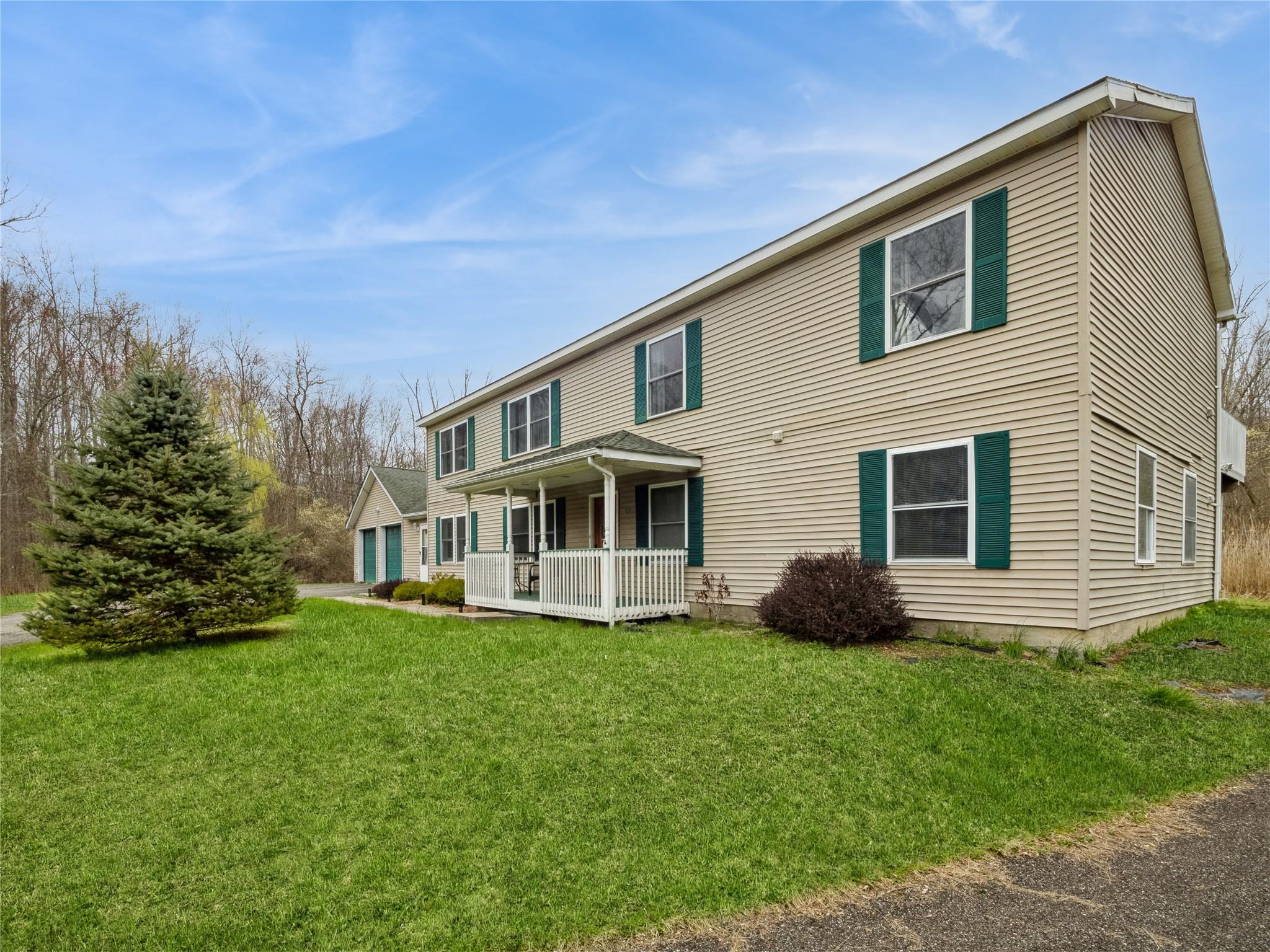 29 Dandelion Lane Wallkill, NY 12589 - Photo 5 of 50 a front view of a house with a yard and trees