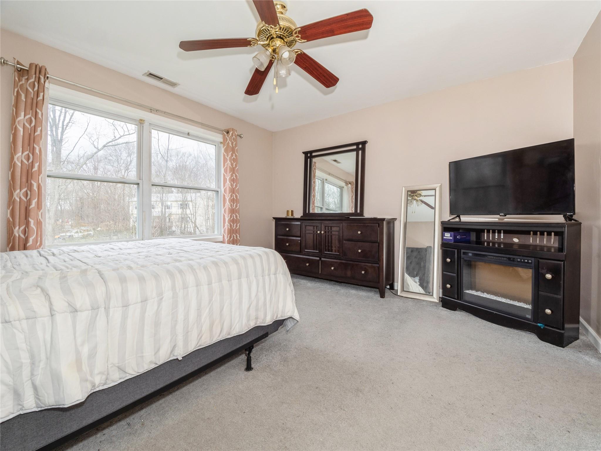 29 Dandelion Lane Wallkill, NY 12589 - Photo 9 of 50 a bedroom with a bed and a flat tv screen on dresser