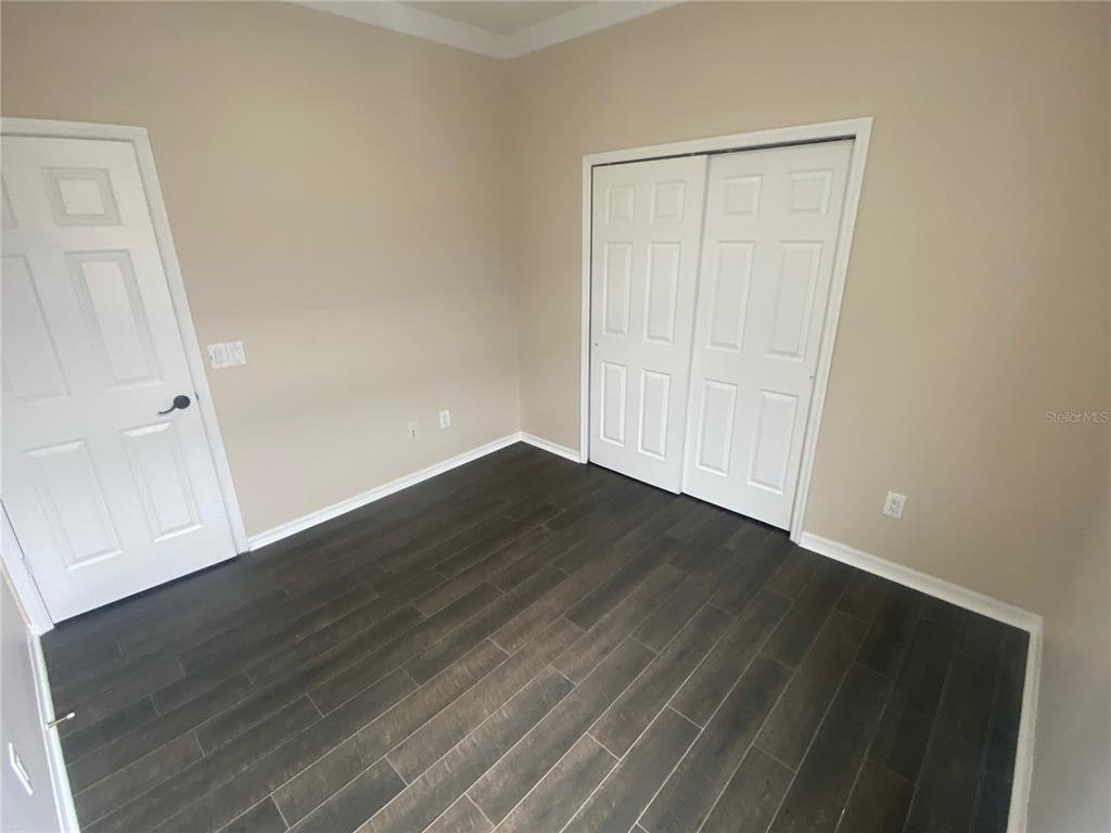 2409 Spring Hollow Loop Wesley Chapel, FL 33544 - Photo 15 of 47 wooden floor in an empty room