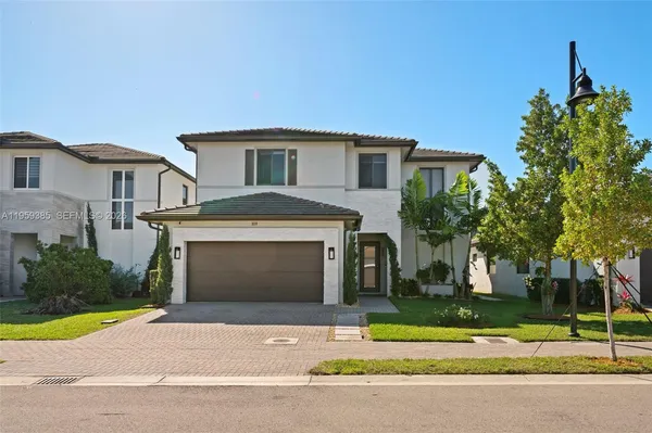 a front view of a house with a yard and garage