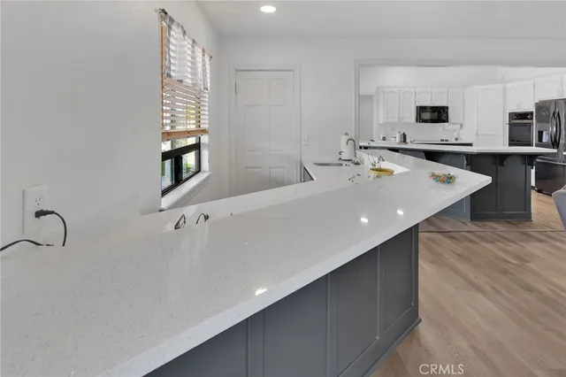 a living room with furniture a fireplace and wooden floor
