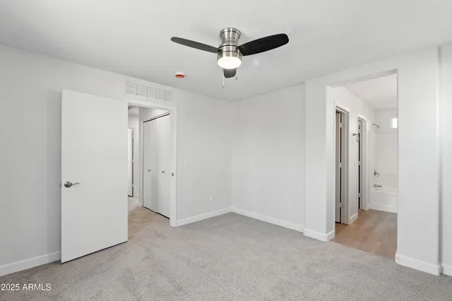 a view of a room with a ceiling fan