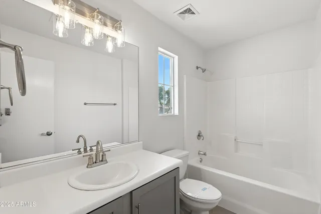 a bathroom with a sink toilet tub and shower