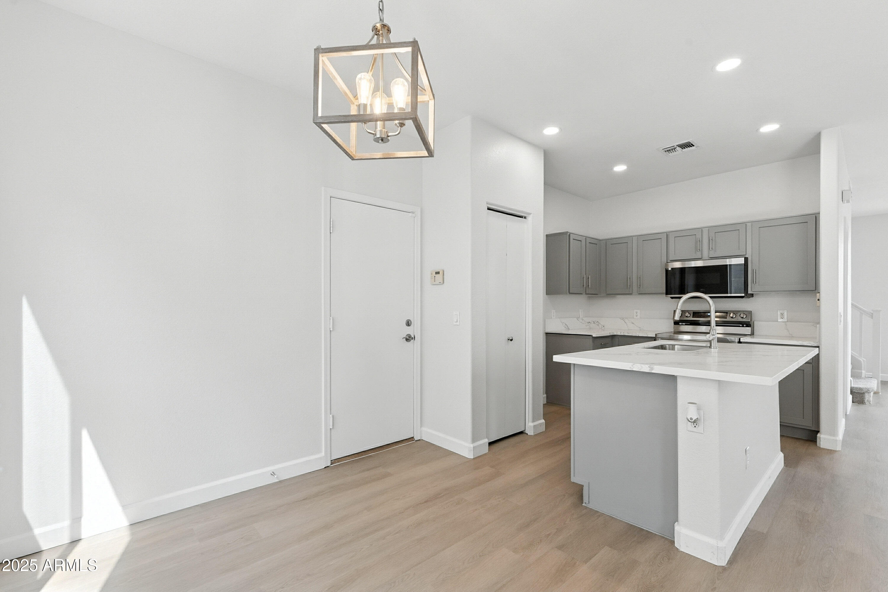 1409 East Bloch Road Phoenix, AZ 85040 - Photo 7 of 24 a kitchen with stainless steel appliances a white stove top oven and cabinets