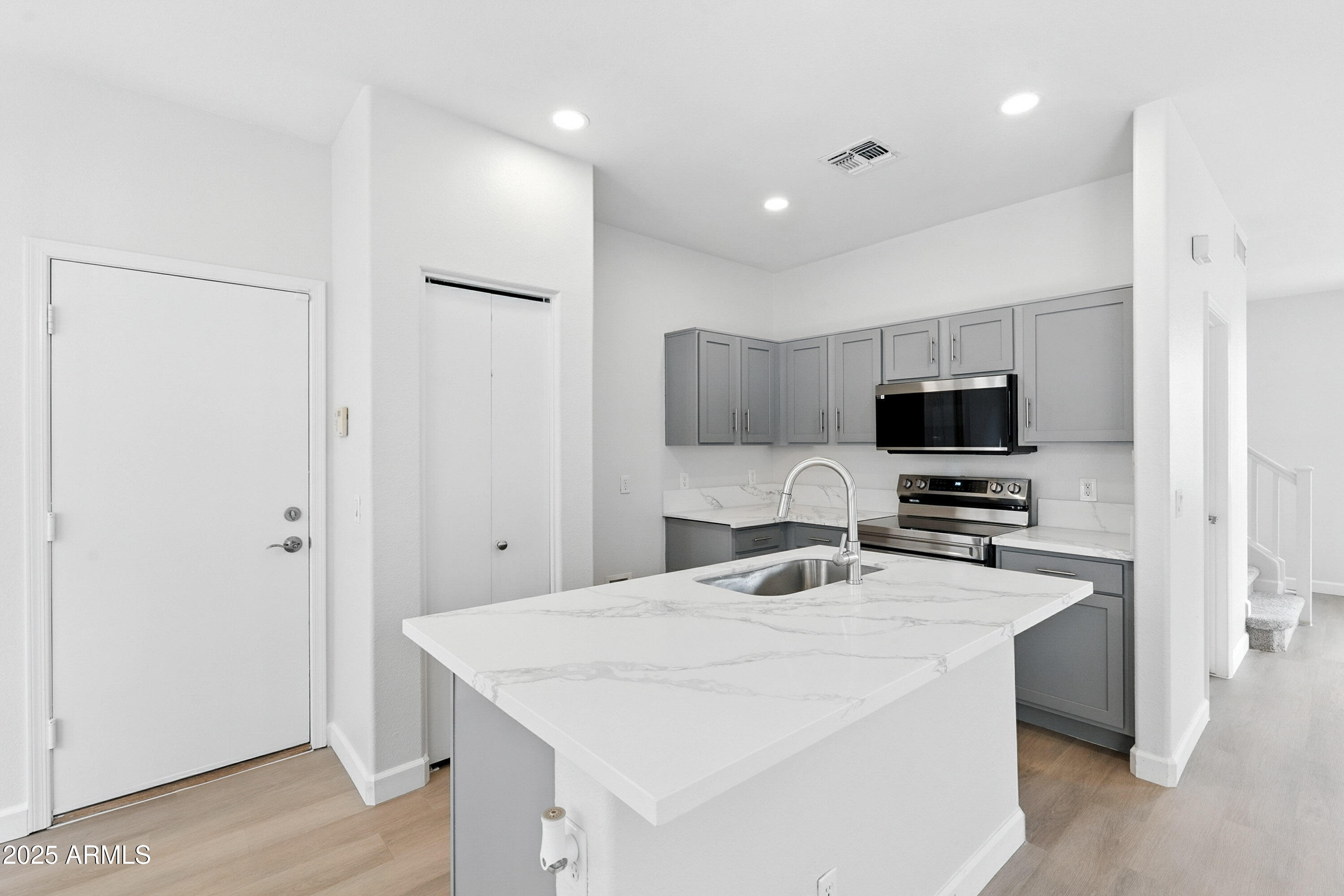 1409 East Bloch Road Phoenix, AZ 85040 - Photo 8 of 24 a kitchen that has a microwave a sink and a refrigerator