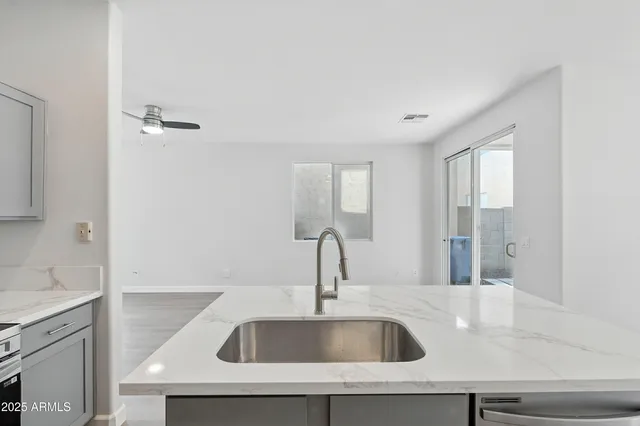a close view of a sink and dishwasher in a bathroom
