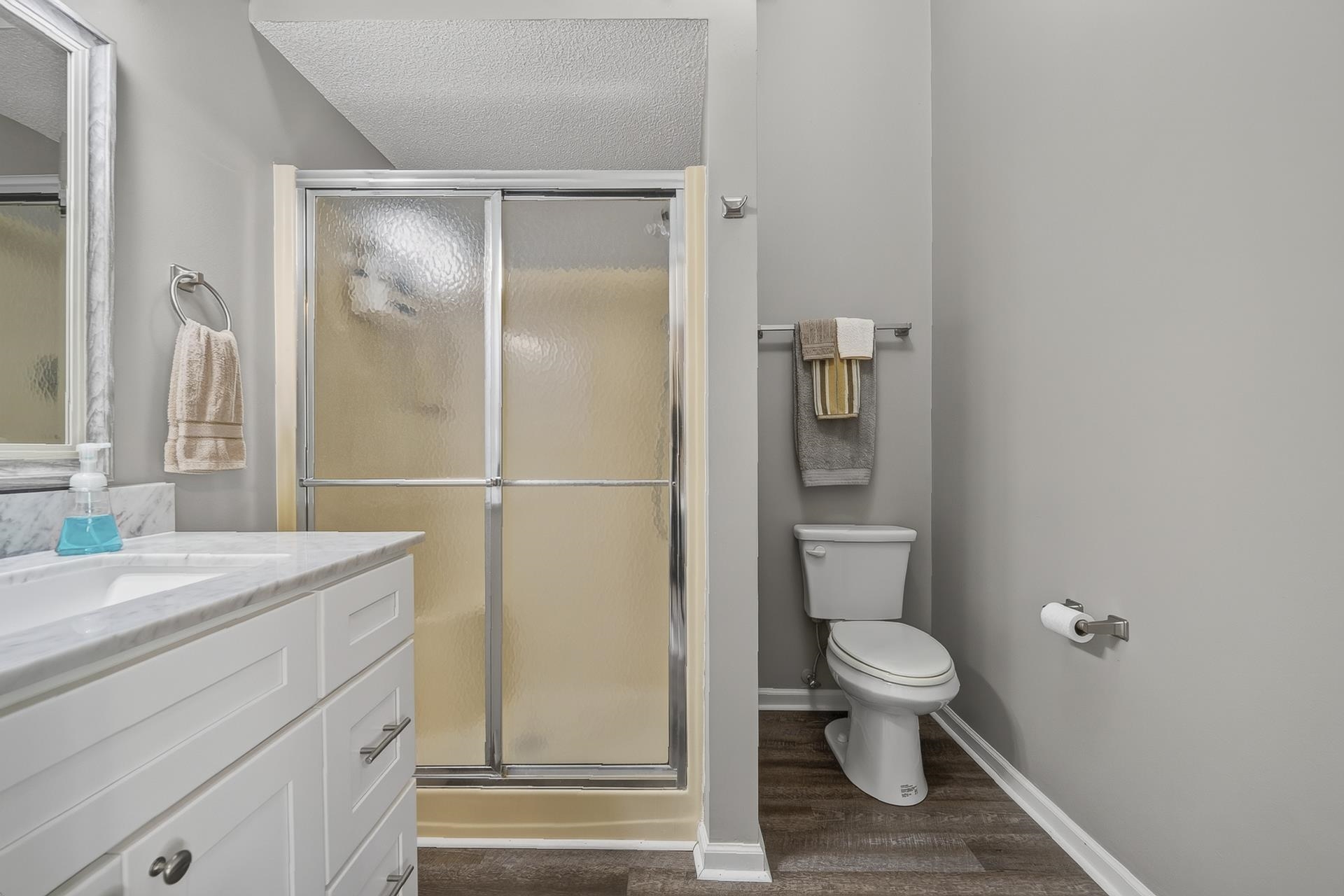 74 Driftwood Road Counce, TN 38326 - Photo 36 of 40 Bathroom featuring a white vanity with a marble-finish countertop and an integrated sink