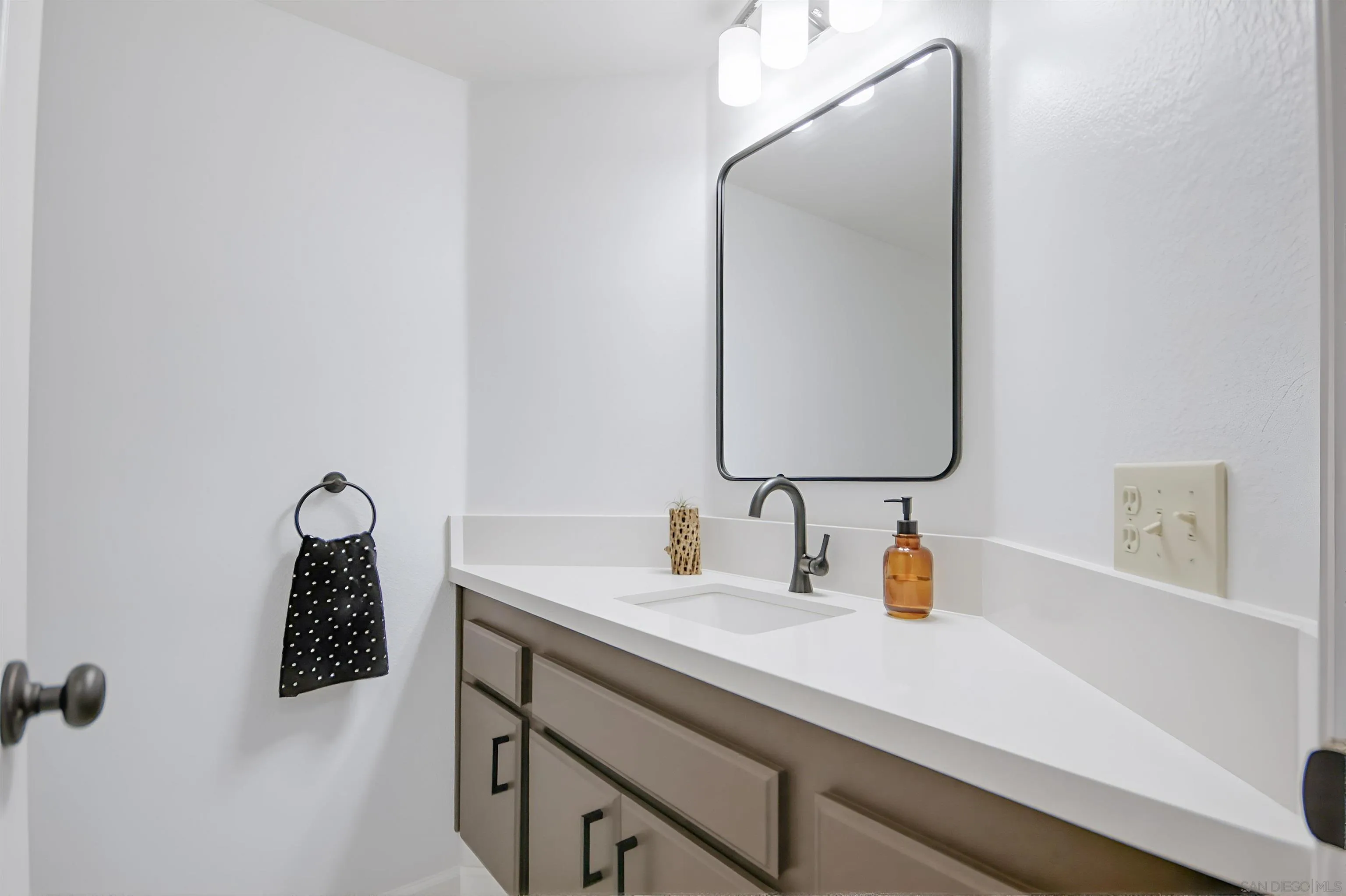 5822 Mission Center Road, Unit A San Diego, CA 92108 - Photo 14 of 35 a bathroom with a sink and a mirror